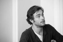 Black and white photo of Tom Mison  